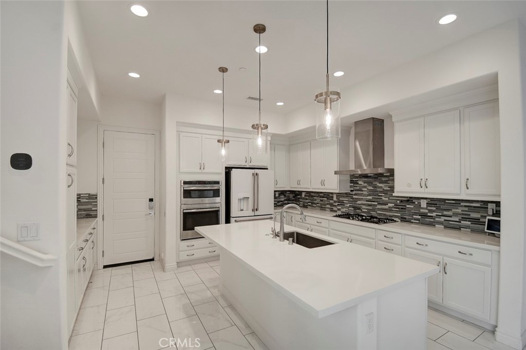 148 Spectacle Irvine, CA 92618 - Photo 10 of 47 a kitchen with a sink a stove a refrigerator and cabinets