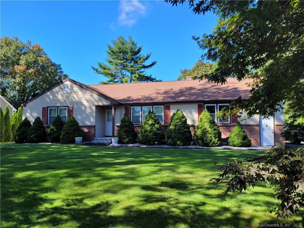 13 B Maxson Road Groton, CT 06340 - Photo 1 of 1 a view of a white house with a big yard and potted plants and large trees