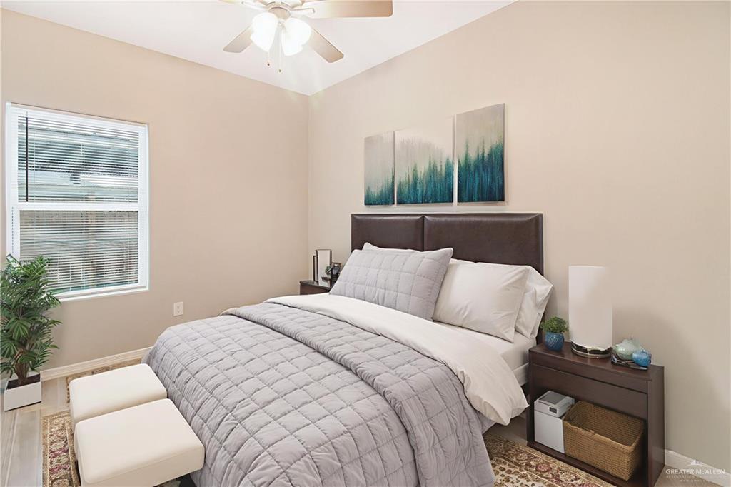 1809 Stauffer Street, Unit 4 Weslaco, TX 78596 - Photo 8 of 12 Bedroom featuring a vaulted ceiling and a ceiling fan-property is virtually staged