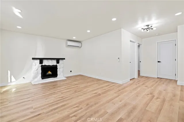 a view of an empty room with a fireplace