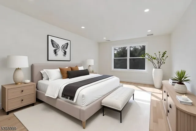 a spacious bedroom with a bed and a large window