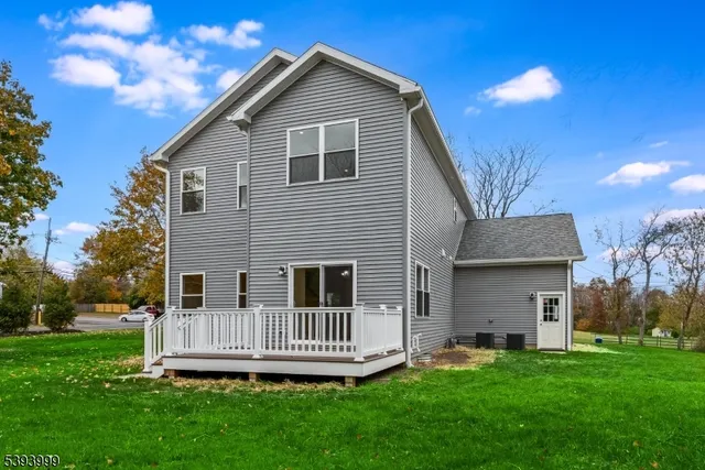 a view of a house with a yard and deck