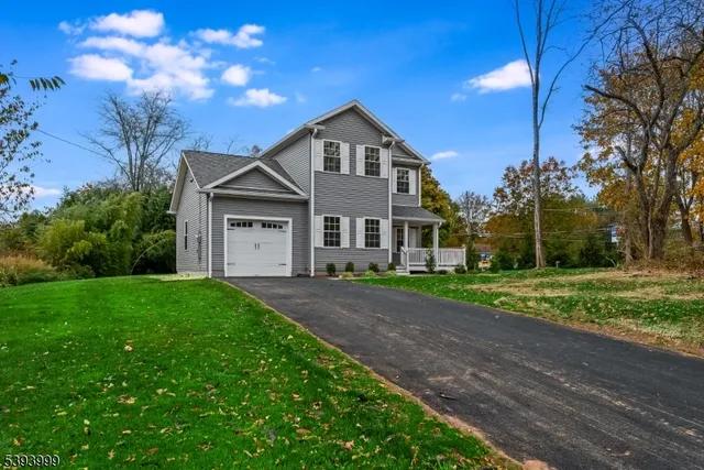a view of a yard in front of a house with large trees