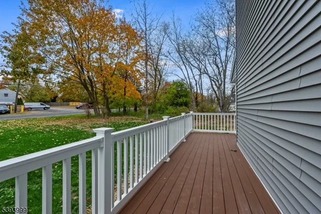 a view of a balcony with wooden floor
