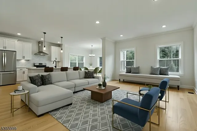 a living room with furniture kitchen view and a large window