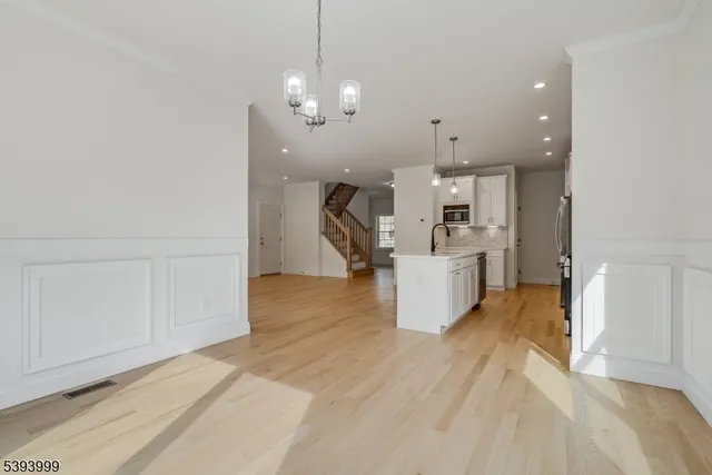 a view of a kitchen with furniture and wooden floor