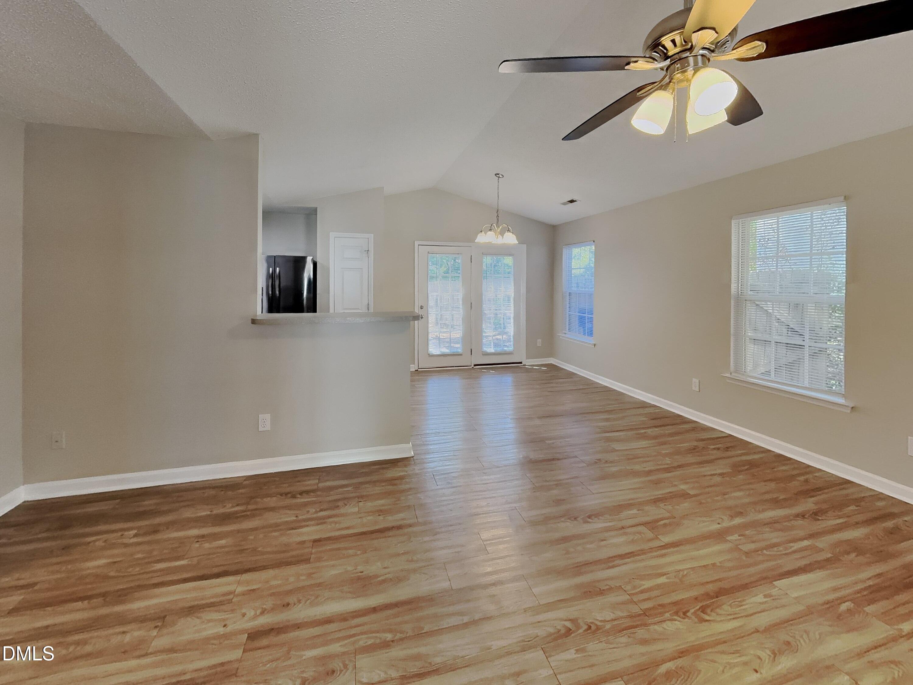 5516 Wilhagan Court Raleigh, NC 27616 - Photo 2 of 16 a view of an empty room with window and wooden floor