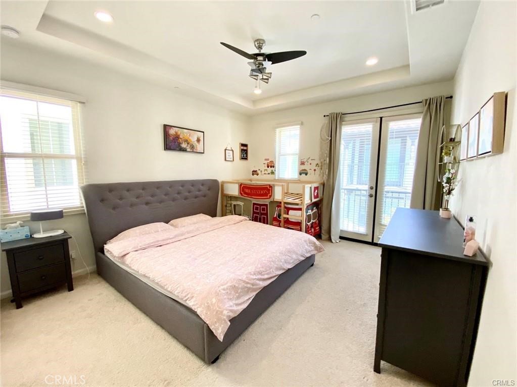62 Emerald Clover Irvine, CA 92620 - Photo 11 of 15 a bedroom with a large bed and a chandelier