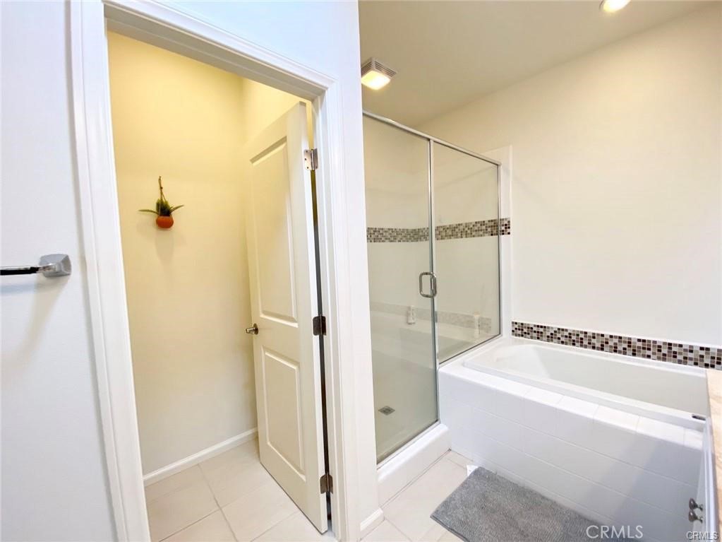 62 Emerald Clover Irvine, CA 92620 - Photo 12 of 15 a bathroom with a tub and shower