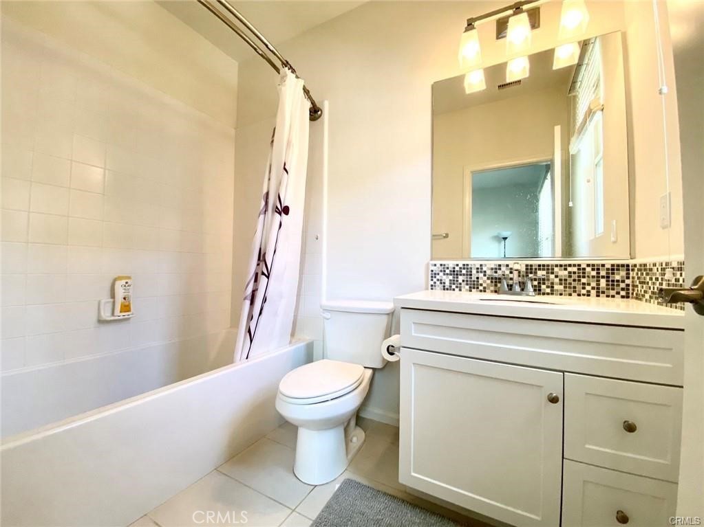62 Emerald Clover Irvine, CA 92620 - Photo 14 of 15 a bathroom with a sink a toilet and a mirror