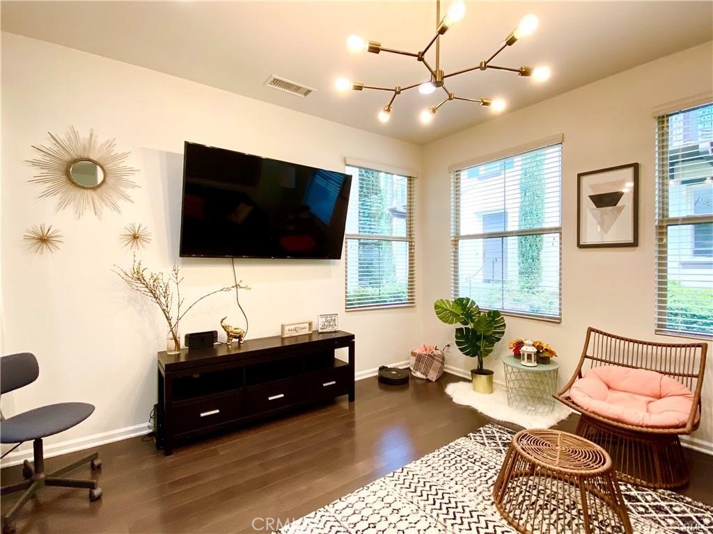 62 Emerald Clover Irvine, CA 92620 - Photo 2 of 15 a living room with furniture and a flat screen tv