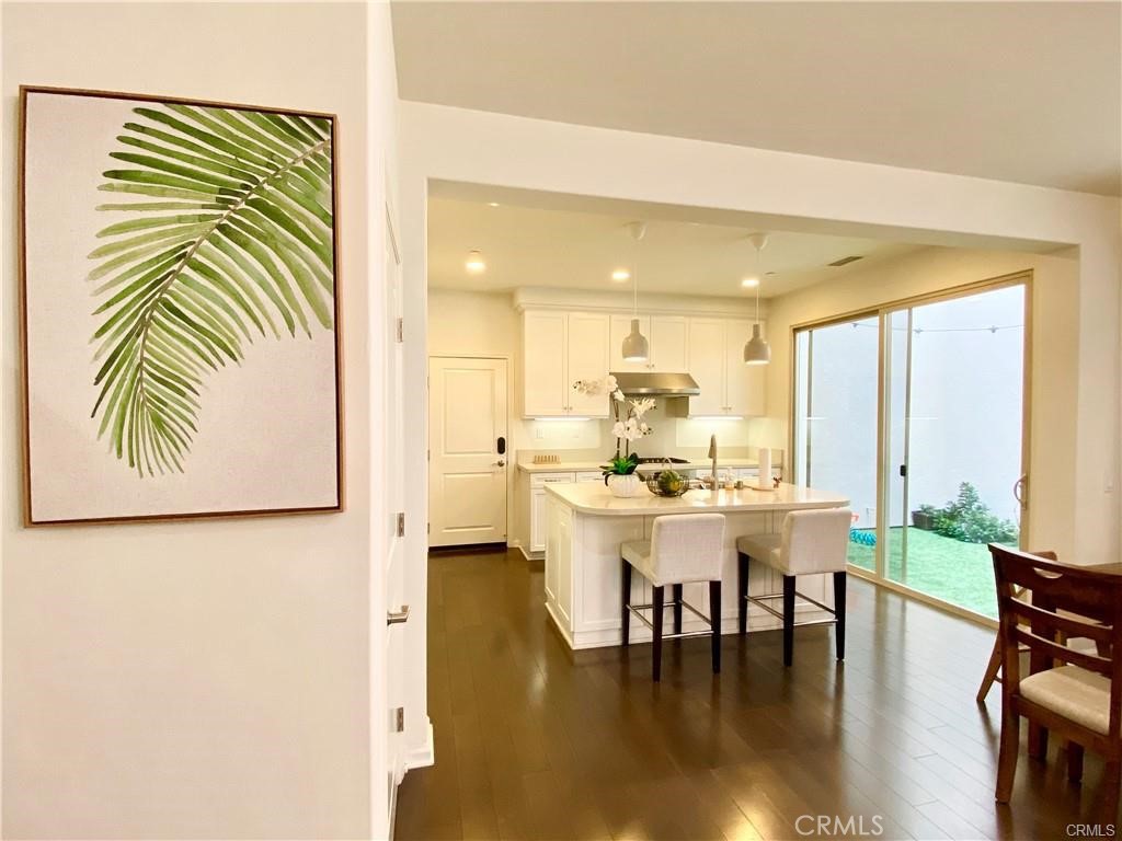 62 Emerald Clover Irvine, CA 92620 - Photo 6 of 15 a view of a dining room with furniture and wooden floor