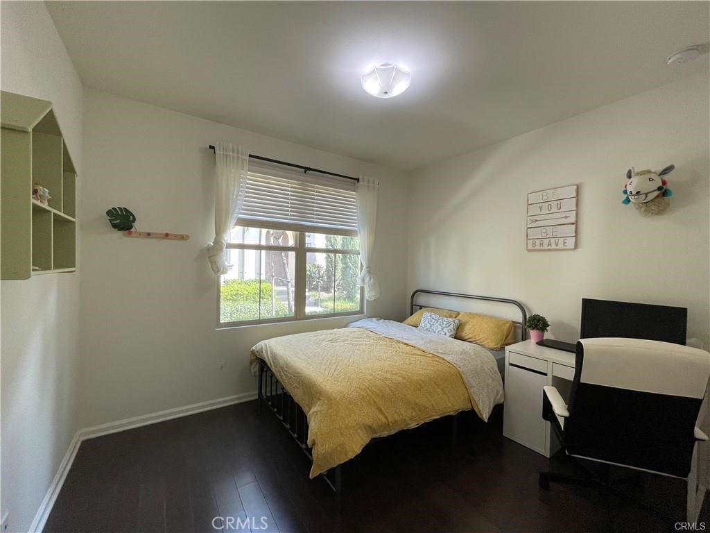62 Emerald Clover Irvine, CA 92620 - Photo 7 of 15 a bedroom with a bed and wooden floor