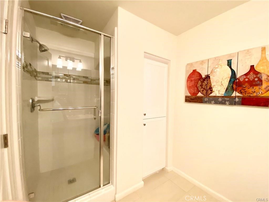 62 Emerald Clover Irvine, CA 92620 - Photo 9 of 15 a bathroom with a glass shower door