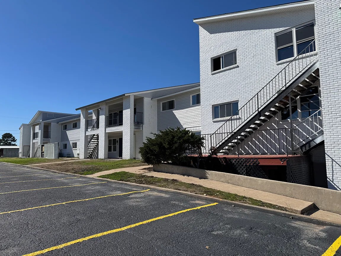345 Fm 86, Unit 6 Luling, TX 78648 - Photo 2 of 2 Uncovered parking lot with stairway and a residential view