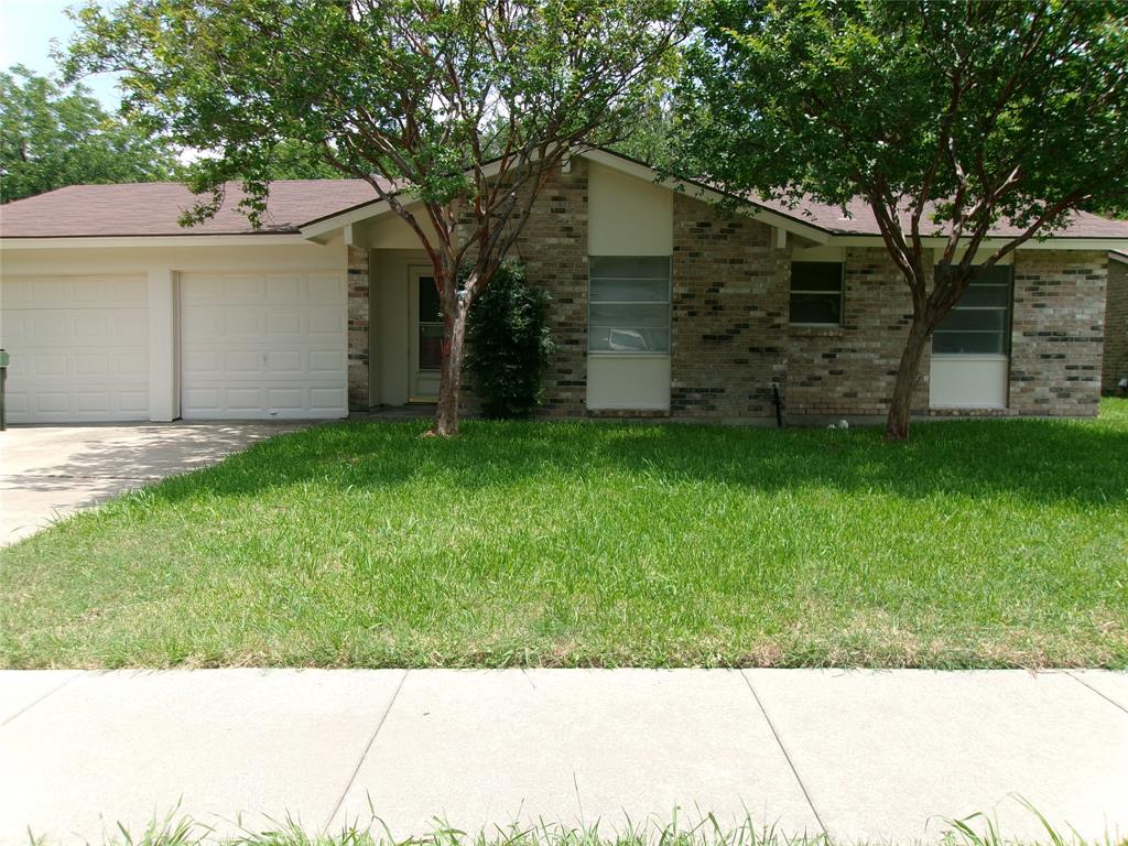 1519 Rambler Road Arlington, TX 76014 - Photo 1 of 21 Brick veneer exterior with a two-car garage, mature trees, a pitched roof, and a concrete sidewalk