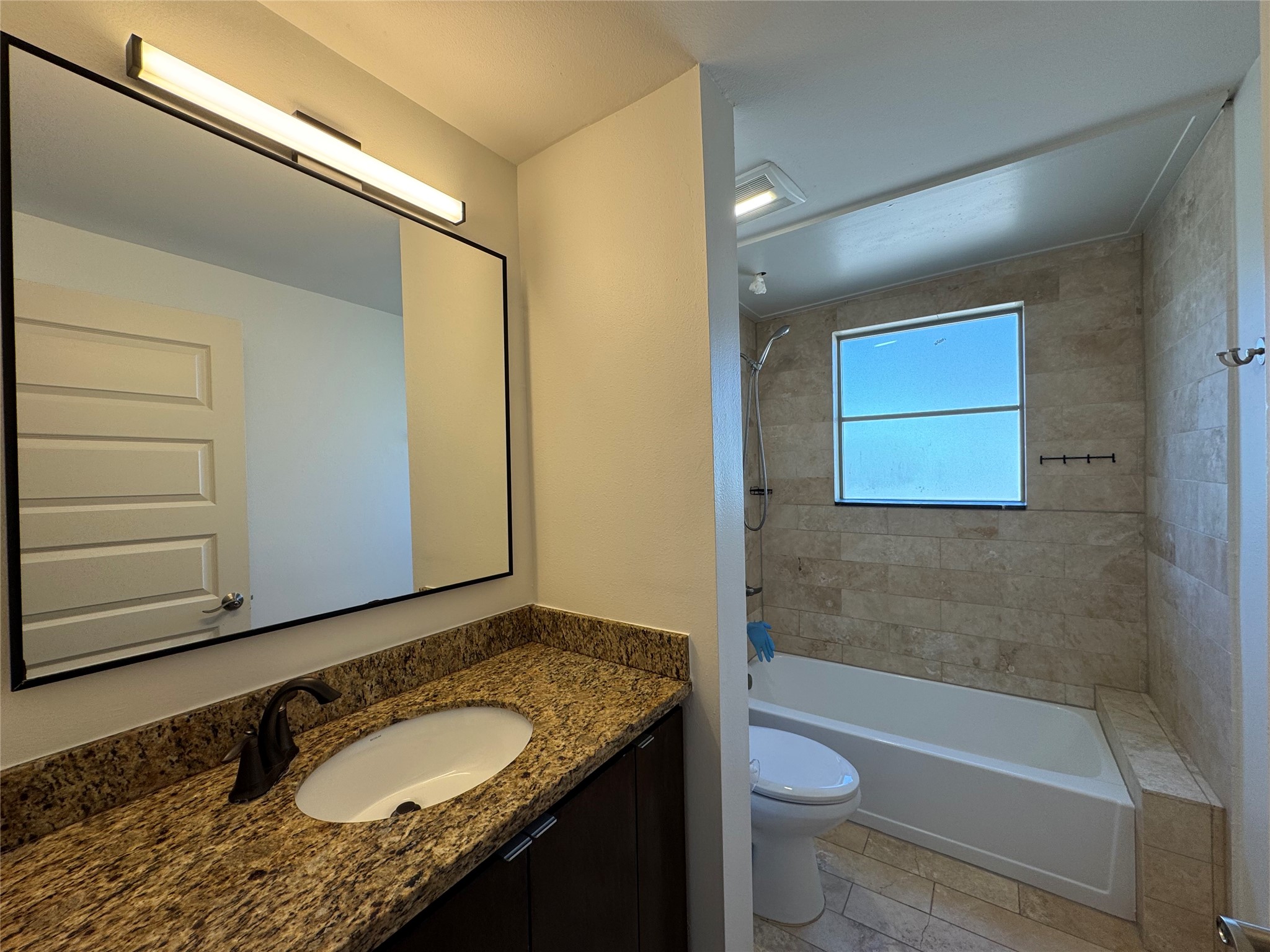 1509 Holman Street, Unit 2 Houston, TX 77004 - Photo 8 of 10 a bathroom with a granite countertop sink toilet and shower