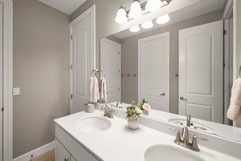 a bathroom with a sink vanity and a mirror