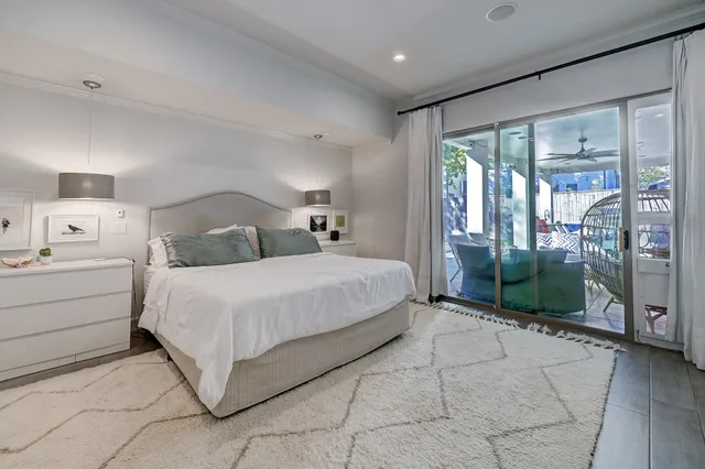 a bedroom with a bed and a glass door