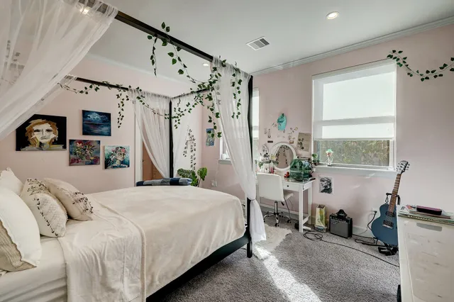 a bedroom with a large bed and a window