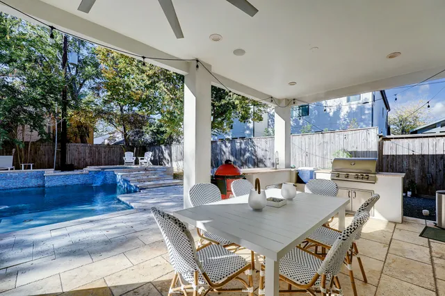 a view of a dining room with furniture large windows and wooden floor