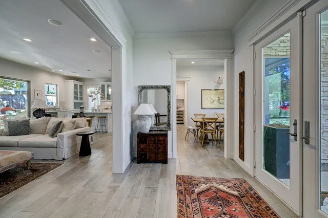 a living room with furniture and a dining table with kitchen view