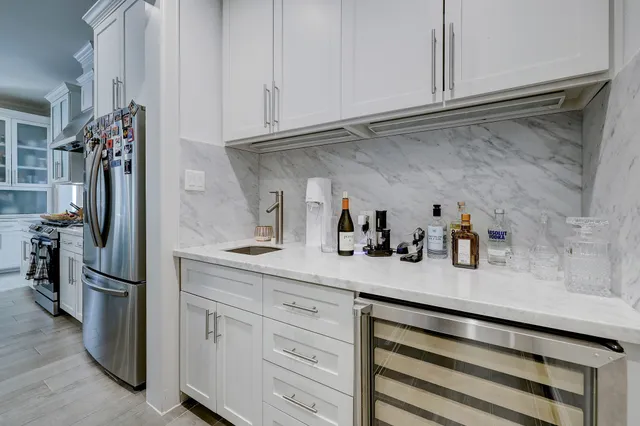 a kitchen with cabinets and a refrigerator