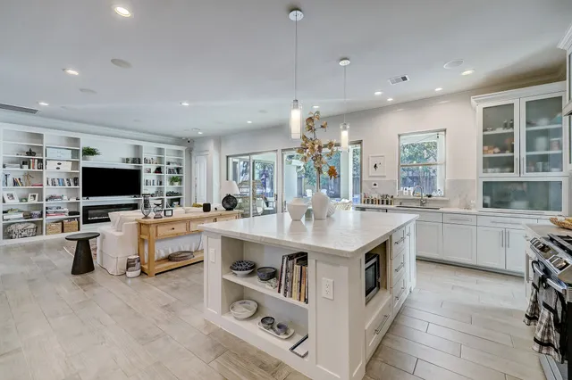 a large kitchen with kitchen island a sink a counter space and stainless steel appliances