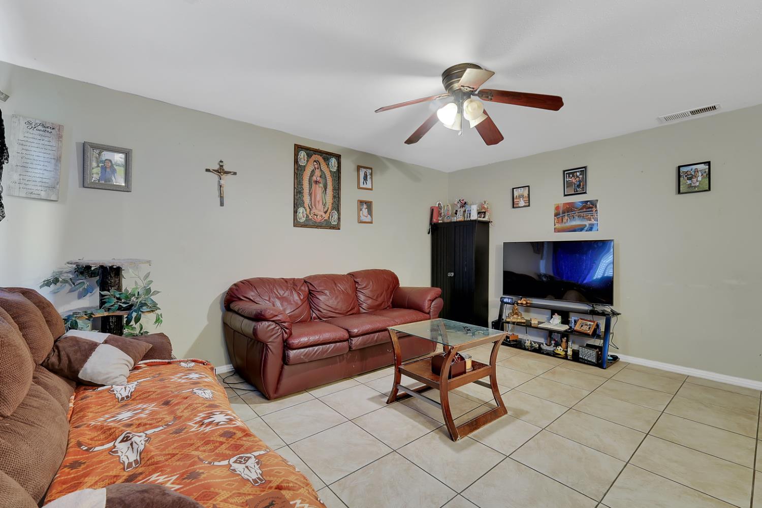 3132 4th Street Biggs, CA 95917 - Photo 11 of 21 a living room with furniture and a flat screen tv