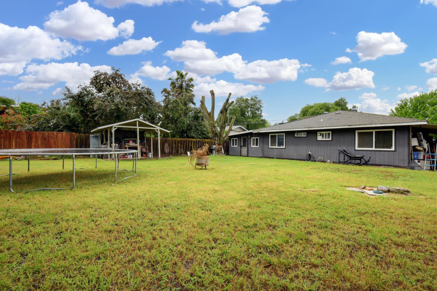 3132 4th Street Biggs, CA 95917 - Photo 6 of 21 a view of a house with swimming pool and a yard