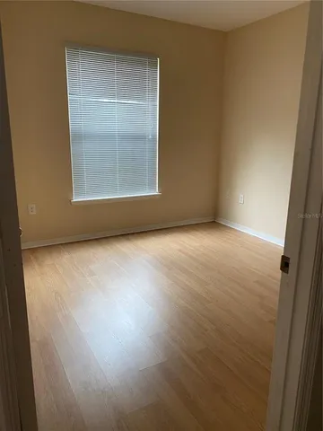 an empty room with windows and closet