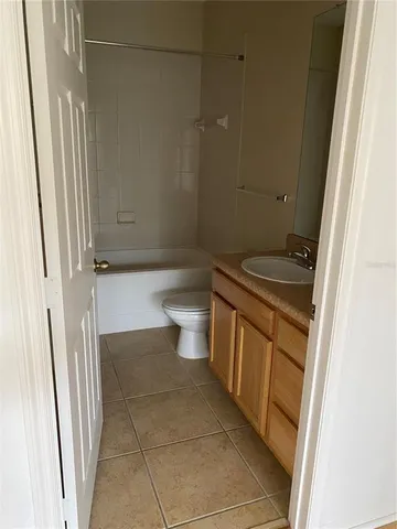 a bathroom with a granite countertop sink a toilet a mirror and shower