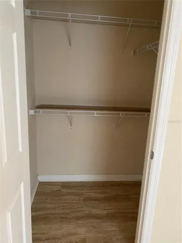 a view of a room with wooden floor