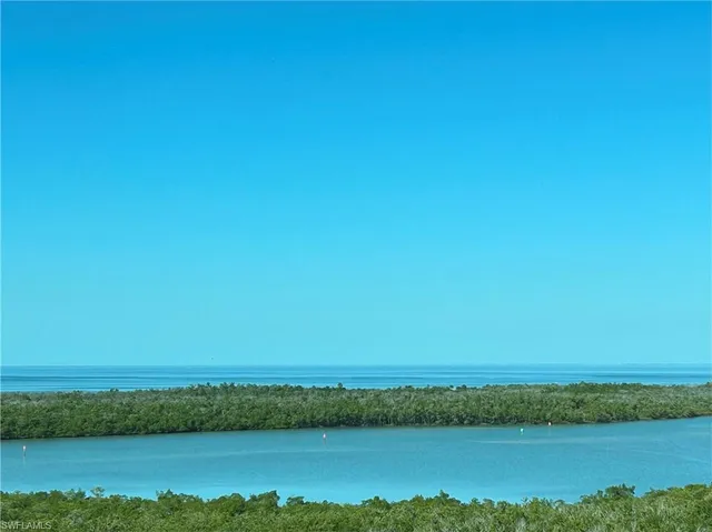 a view of a field with an ocean beach
