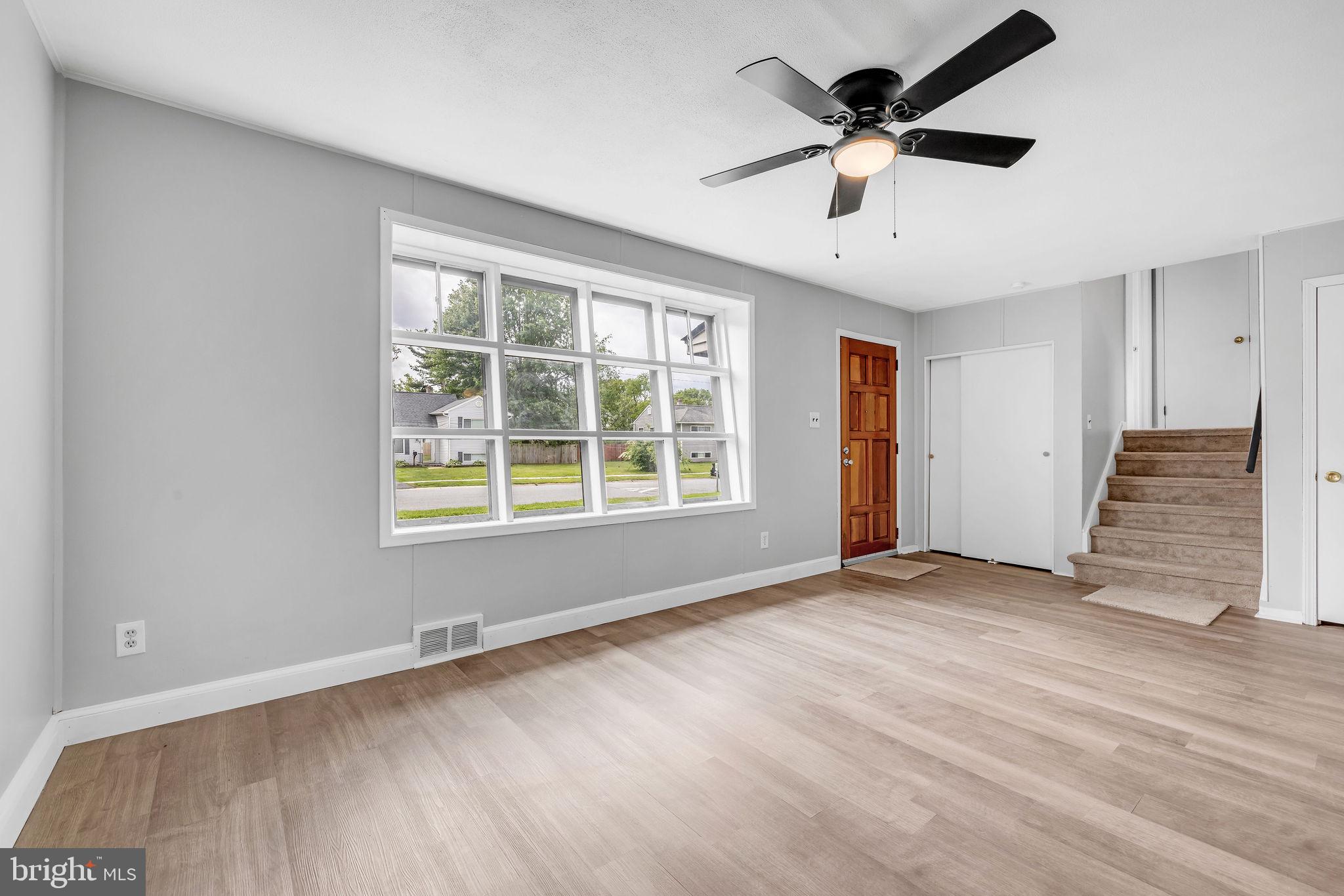 136 Brookside Boulevard Newark, DE 19713 - Photo 3 of 31 a view of an empty room with a window and wooden floor