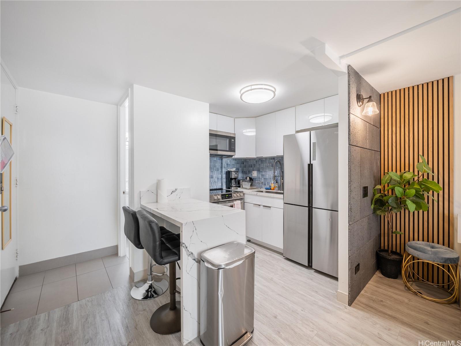 2572 Lemon Road, Unit 610 Honolulu, HI 96815 - Photo 11 of 24 a kitchen with a refrigerator a sink and dishwasher