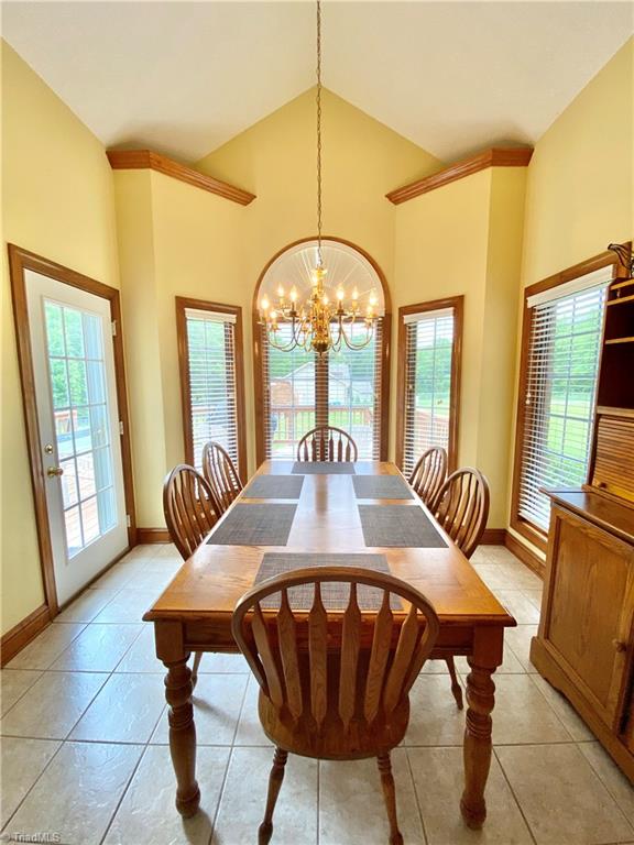 121 Belewsfield Road Stokesdale, NC 27357 - Photo 5 of 30 Breakfast area with vaulted ceiling. Exterior door leads to deck.