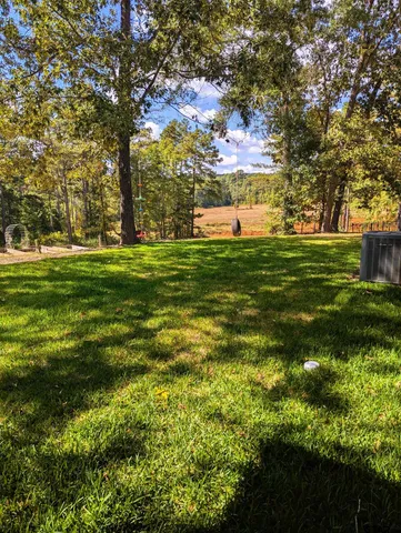 a sign board with big trees