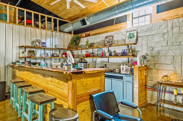 a view of a kitchen with a dining table chairs and iron stairs