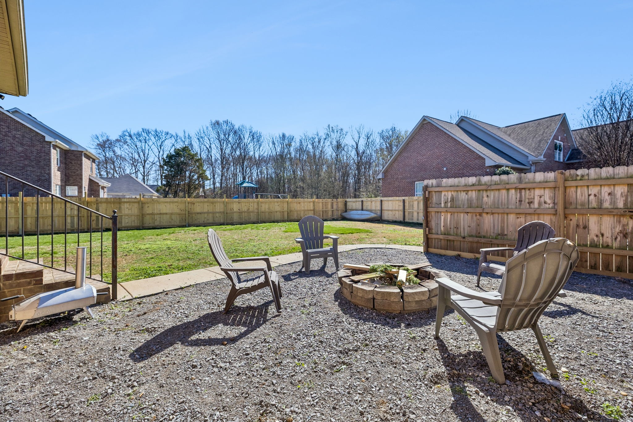 3918 Rowland Road Murfreesboro, TN 37128 - Photo 34 of 50 a view of a backyard with table and chairs under an umbrella