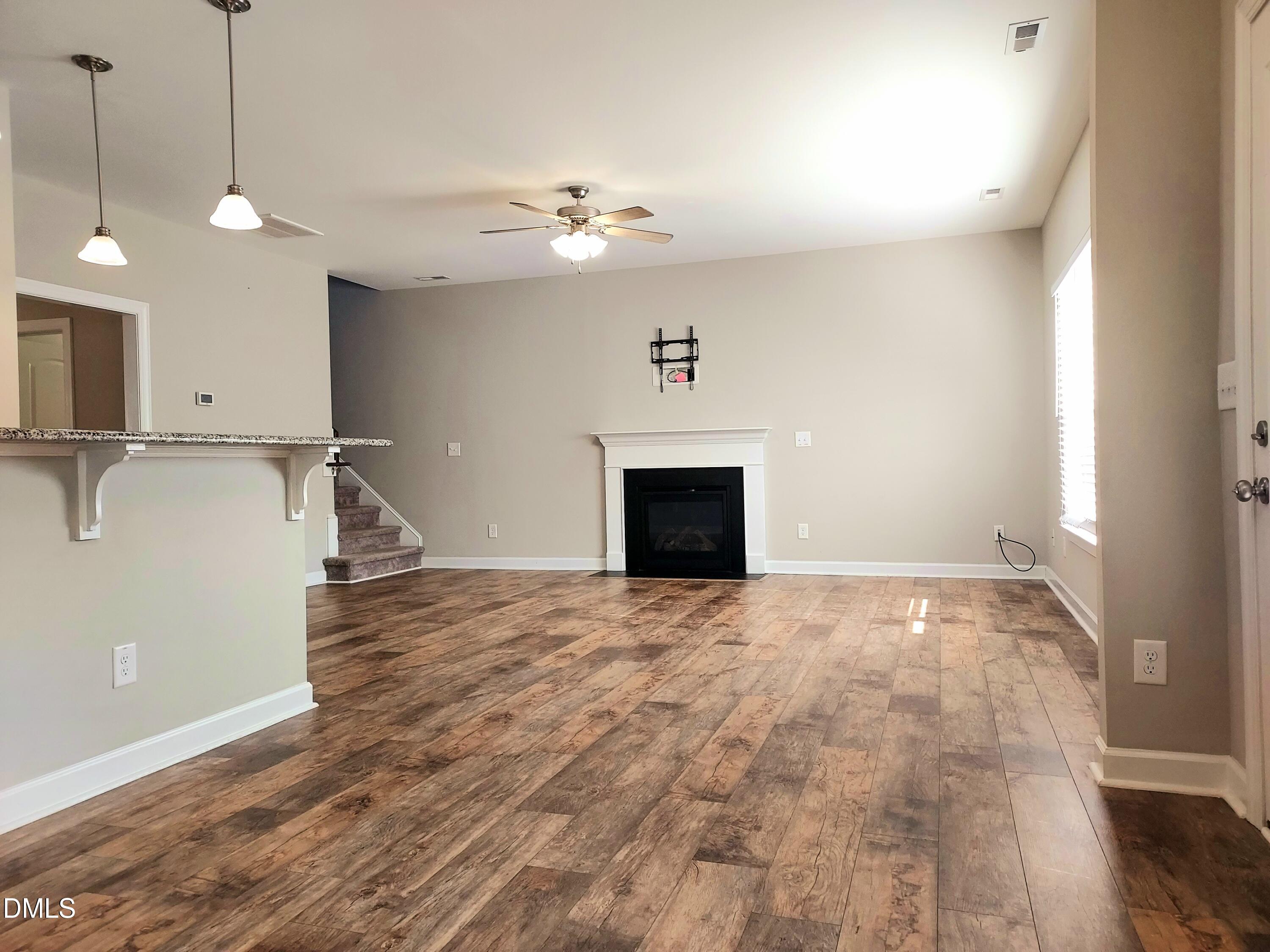 255 Kenbridge Lane Princeton, NC 27569 - Photo 13 of 98 a view of an empty room with a fireplace and a window