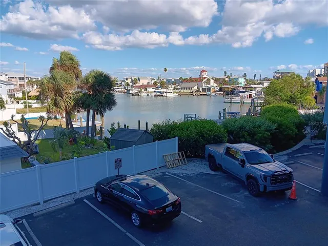 a swimming pool with outdoor seating and barbeque oven