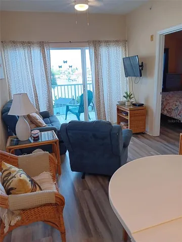 a kitchen with a table chairs sink and cabinets
