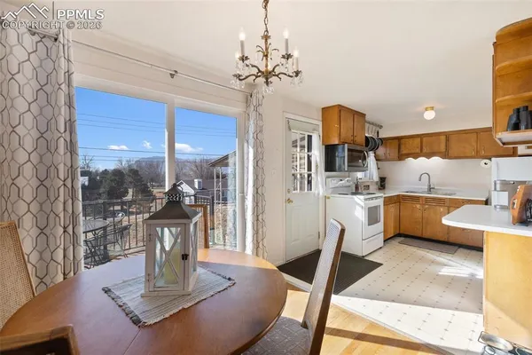 a kitchen that has a lot of white cabinets and stainless steel appliances