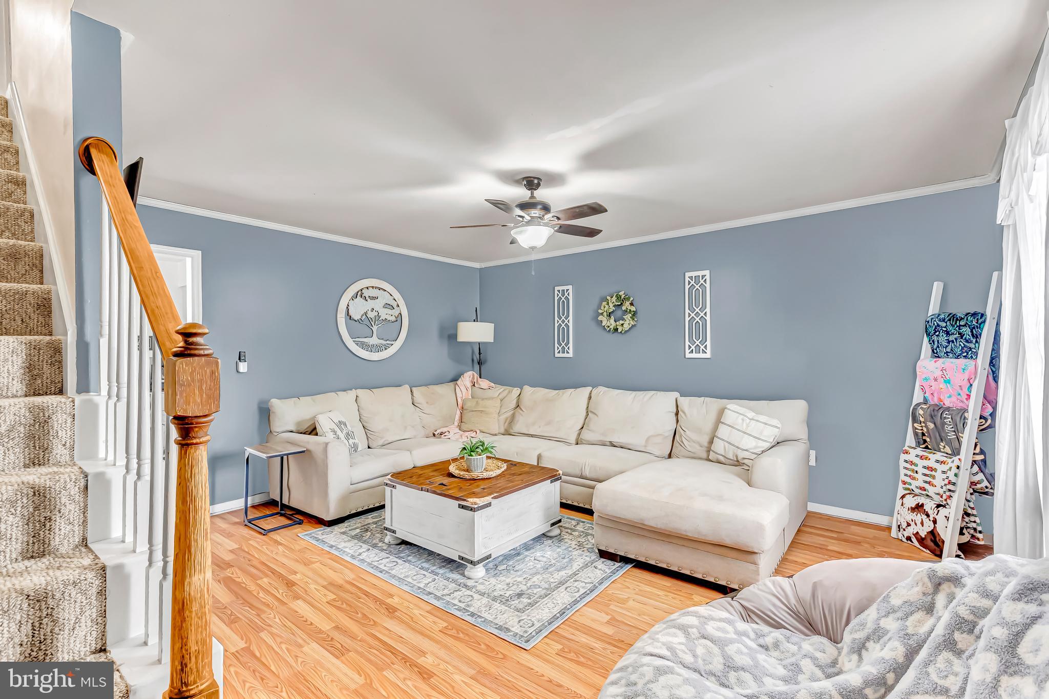 4925 Campground Road Eden, MD 21822 - Photo 2 of 42 a living room with furniture a clock on wall and a window