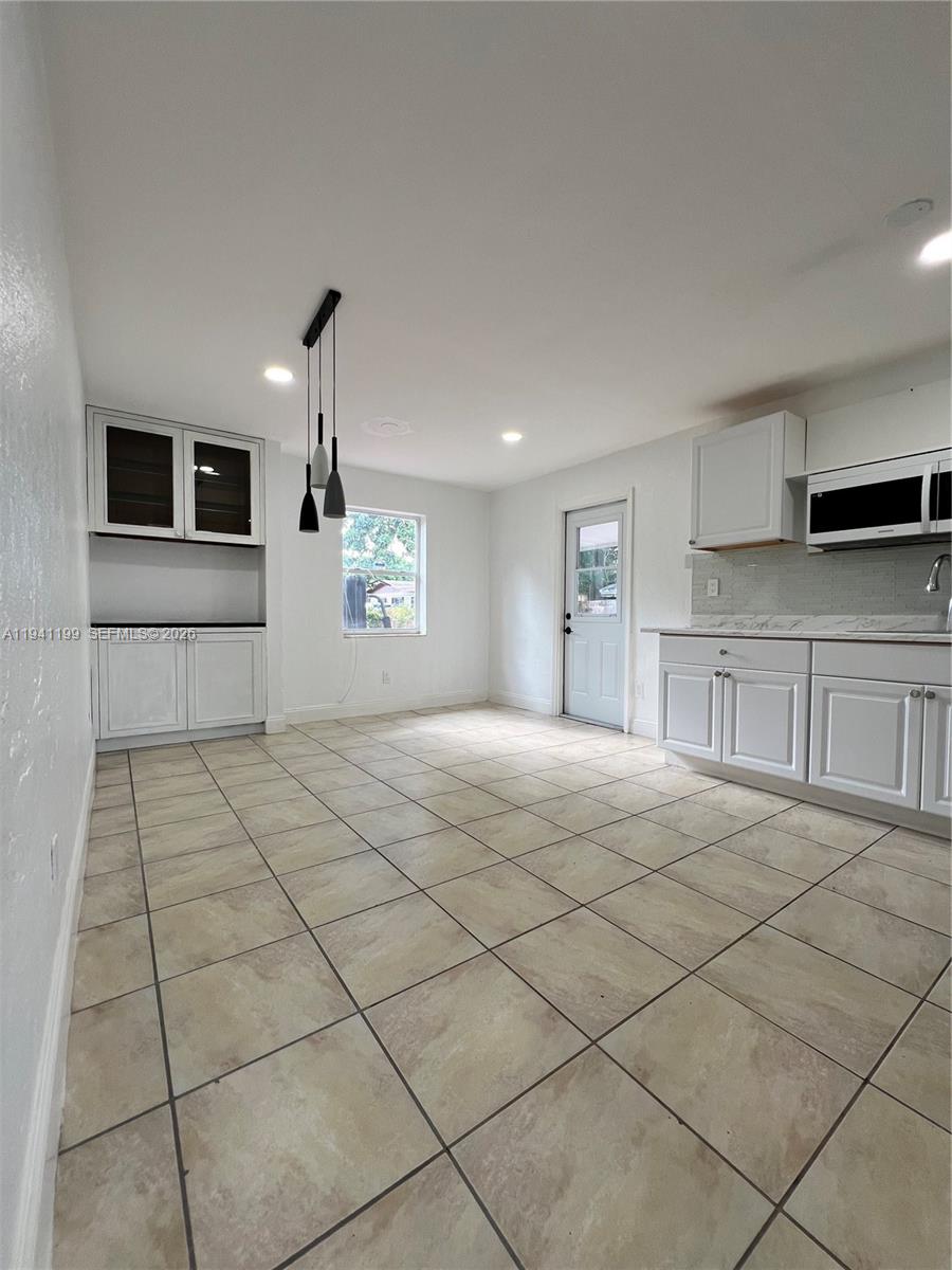 15400 Southwest 295th Street Homestead, FL 33033 - Photo 14 of 38 a spacious bedroom with a bed and a cabinets