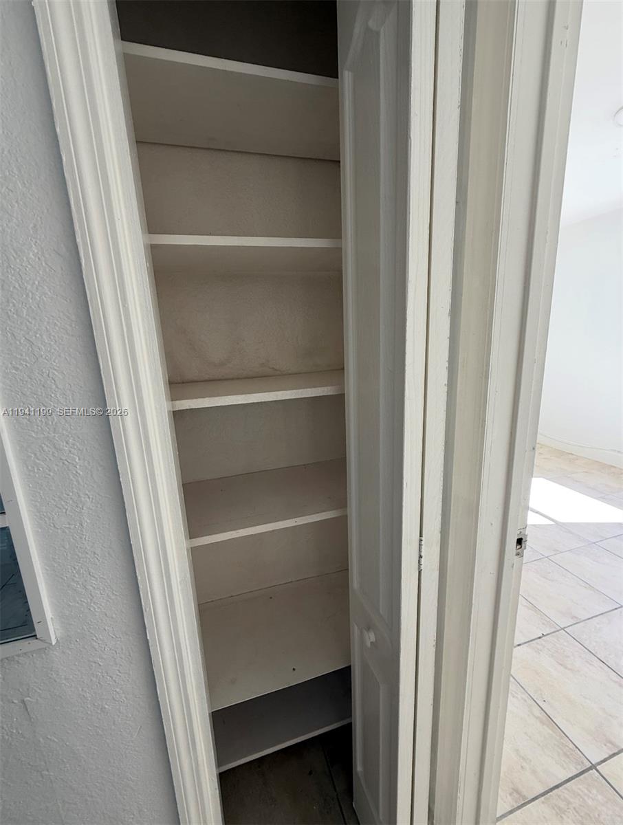 15400 Southwest 295th Street Homestead, FL 33033 - Photo 16 of 38 a view of walk in closet with empty racks
