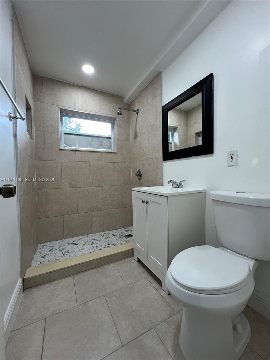 15400 Southwest 295th Street Homestead, FL 33033 - Photo 19 of 38 a bathroom with a toilet a sink a mirror and vanity