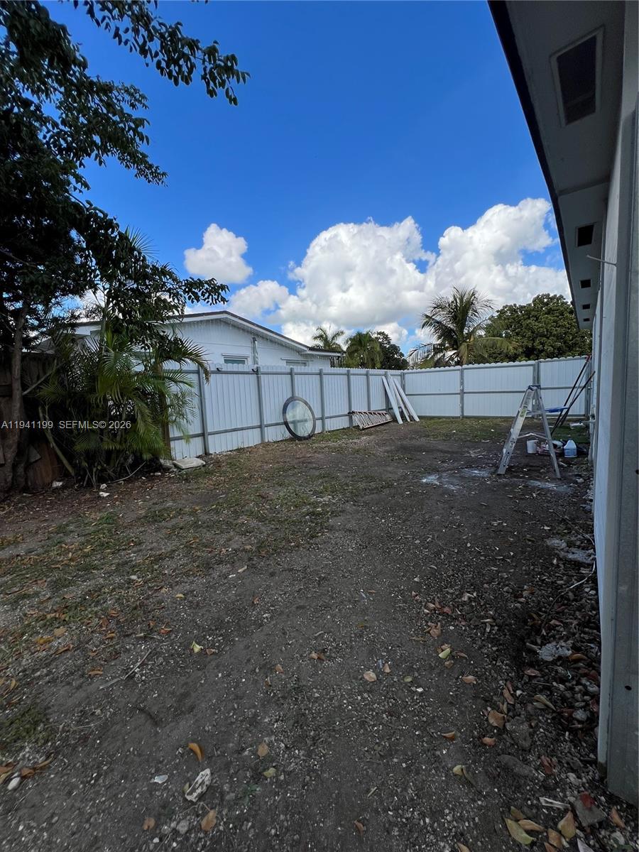 15400 Southwest 295th Street Homestead, FL 33033 - Photo 29 of 38 a view of backyard with plants and wooden fence