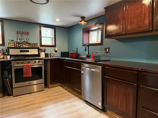 a kitchen with a sink stove and cabinets